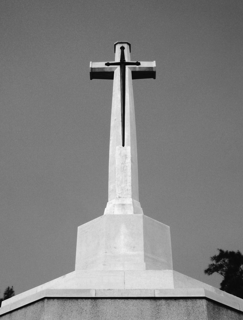 The cemetery is guarded by a large stone cross upon which is superimposed a large bronze inverted sword